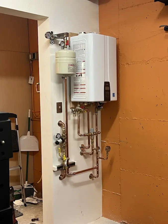 Plumbing technician inspecting water heater connections in Satellite Beach